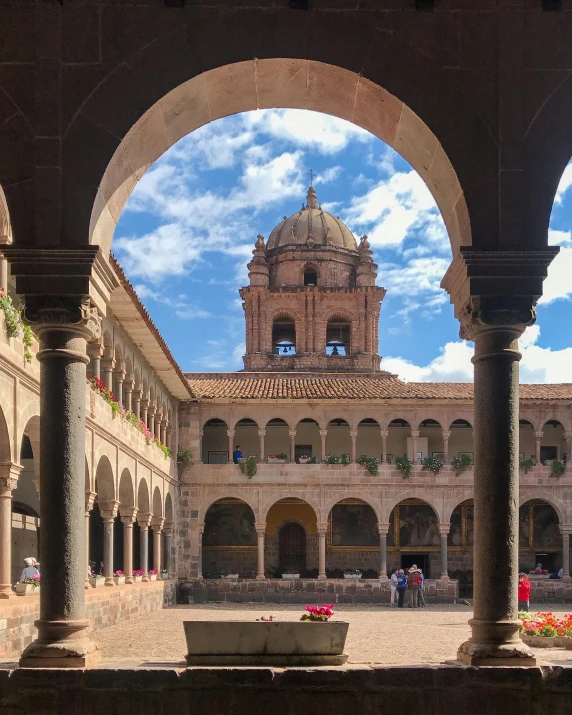 the courtyard and fountain are in arches and around with a blue sky above