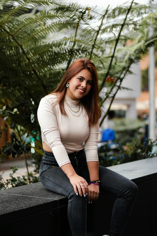 a young woman posing for the camera on a balcony