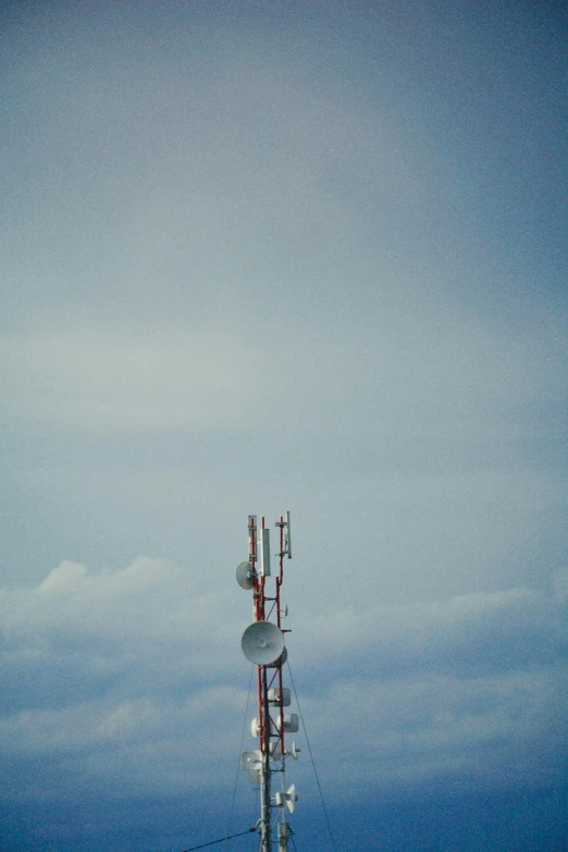 a large telephone tower on top of a hill
