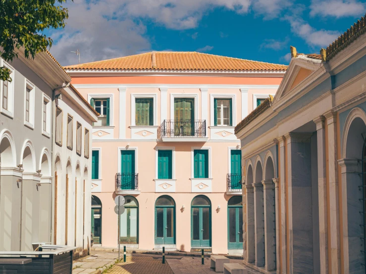 a two story building with a small courtyard behind