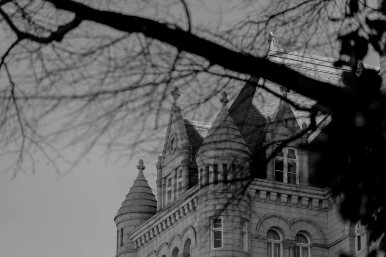 a picture taken from behind a nch looking at the side of a building