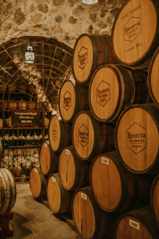 the wooden barrels are stacked together in this winery