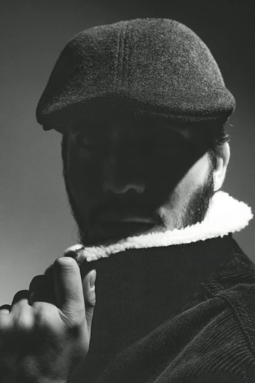 a man wearing a hat is trimming his necktie