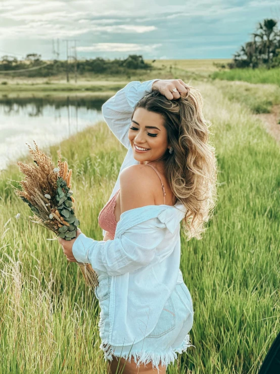 a beautiful woman in a white dress holding flowers