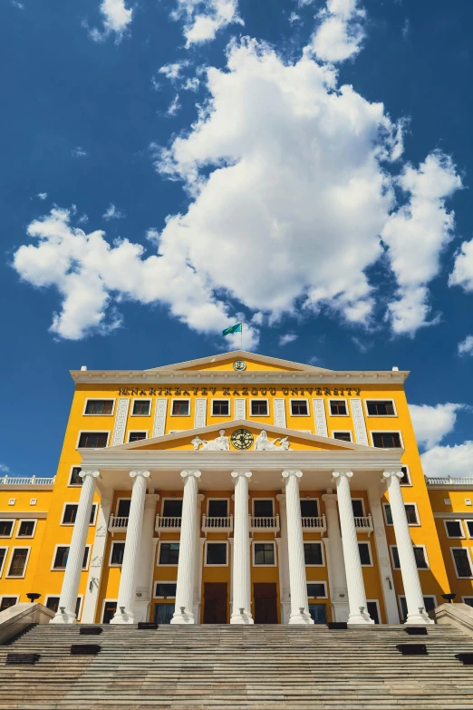 a white and yellow building with a big porch