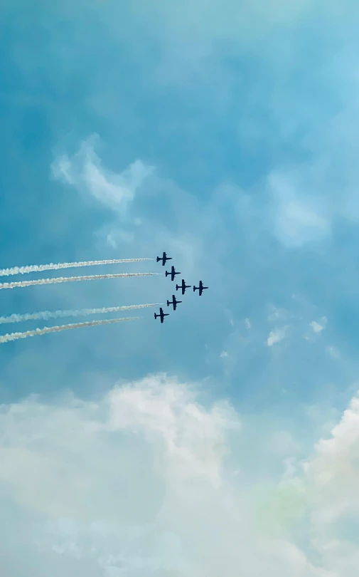 a group of air planes flying together in a blue sky