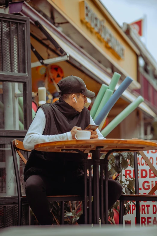 a person is at a table with a cup