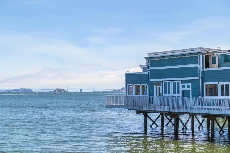 the building is blue and white next to the water