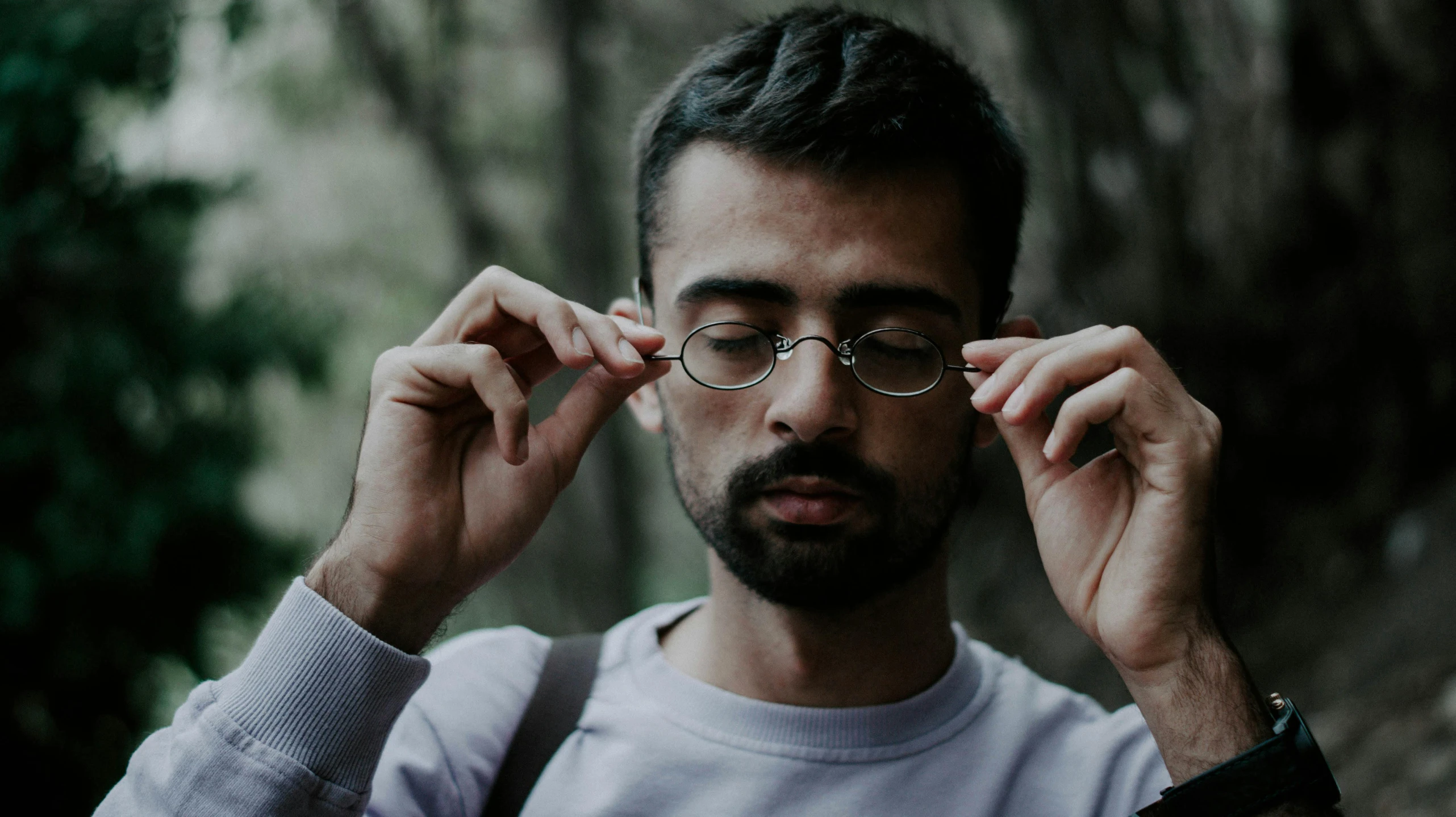 a man wearing glasses and a sweatshirt