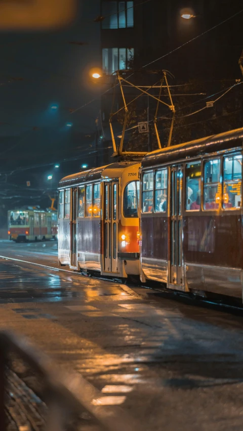 there are three city buses parked on the street