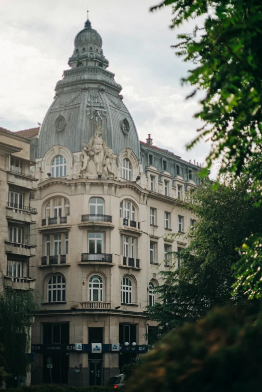 a large building that is behind some trees