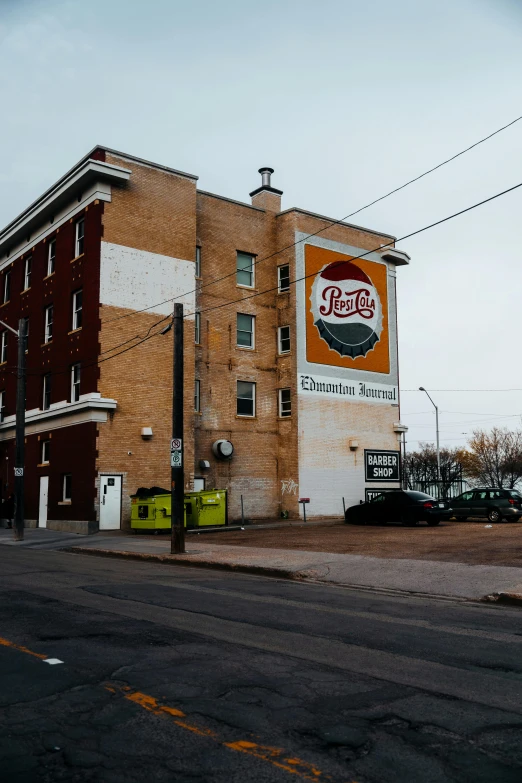 the large building has a very tall brick face