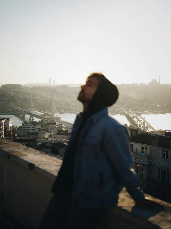 a man is standing on a roof looking at soing