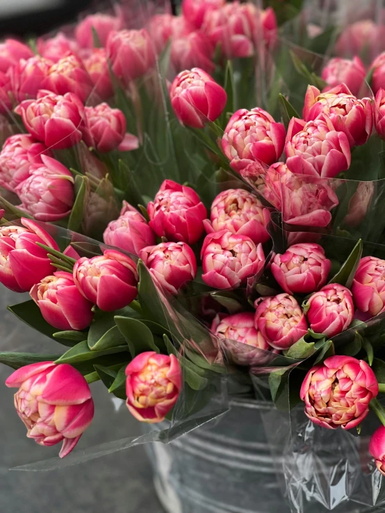 flowers are arranged in vases on the table