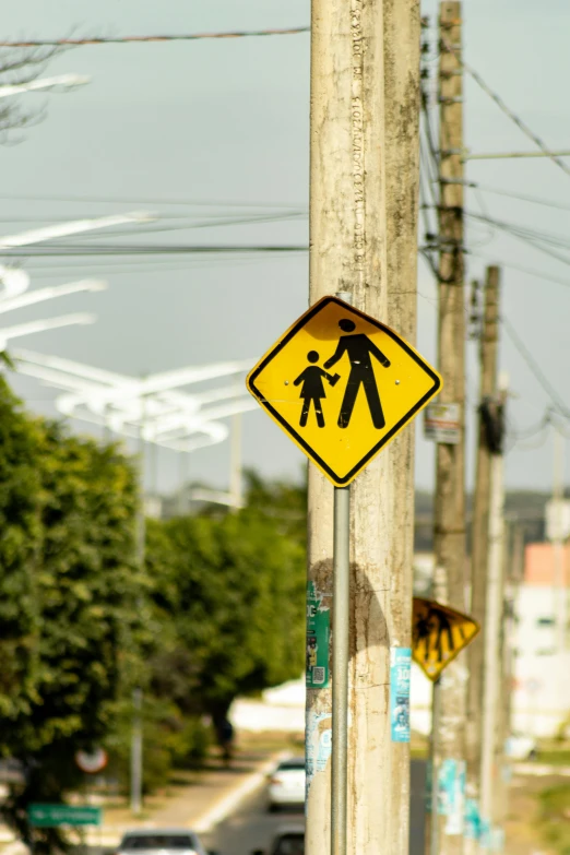 a pedestrian crossing sign on the street