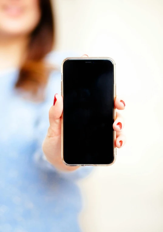 a woman is holding her phone in her hands