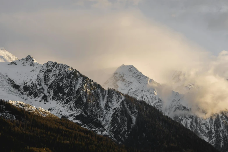 the mountains have snow and mist on them