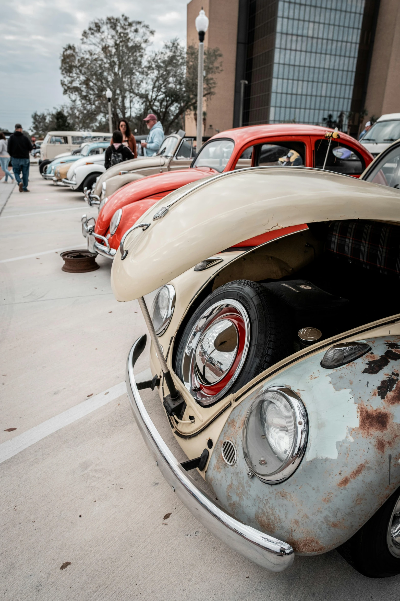 several old cars are parked on the side of the street