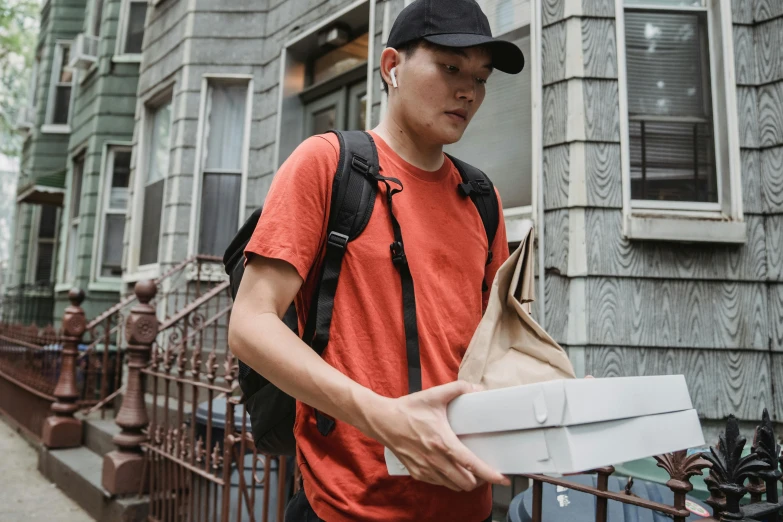 a man with a backpack walking down a street