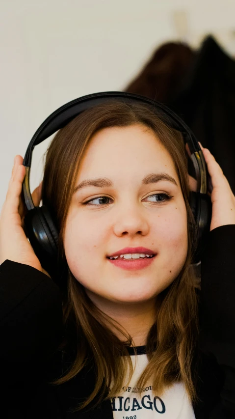 a  is listening to headphones in a room