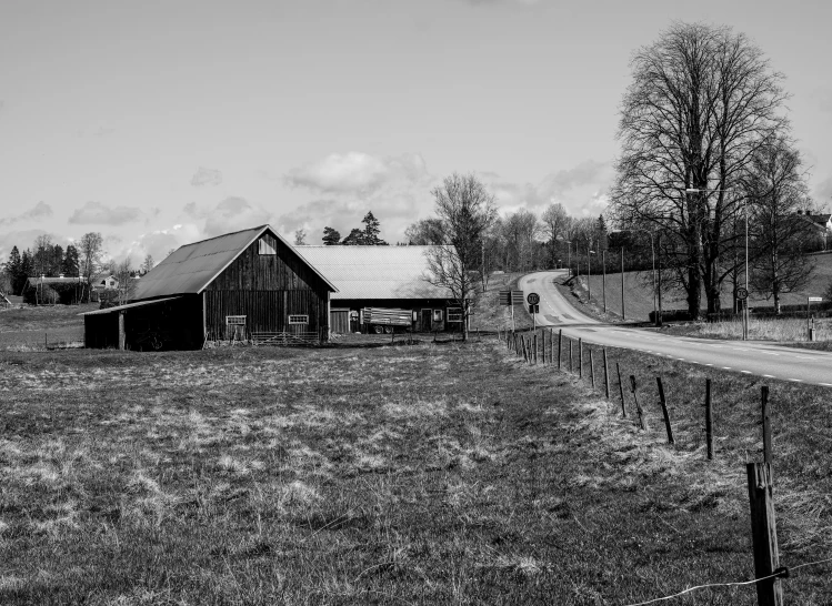 an old black and white pograph of an old barn