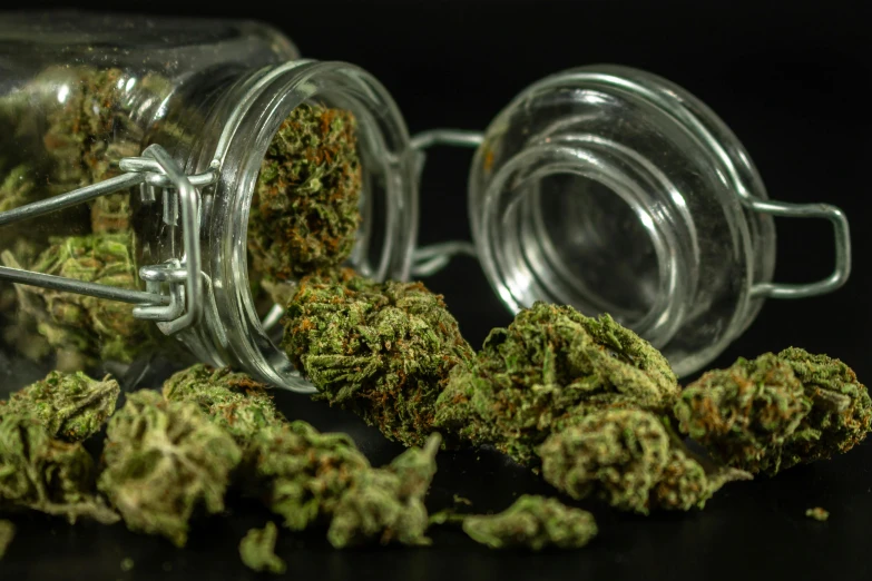 marijuana buds have been spilled out of a jar