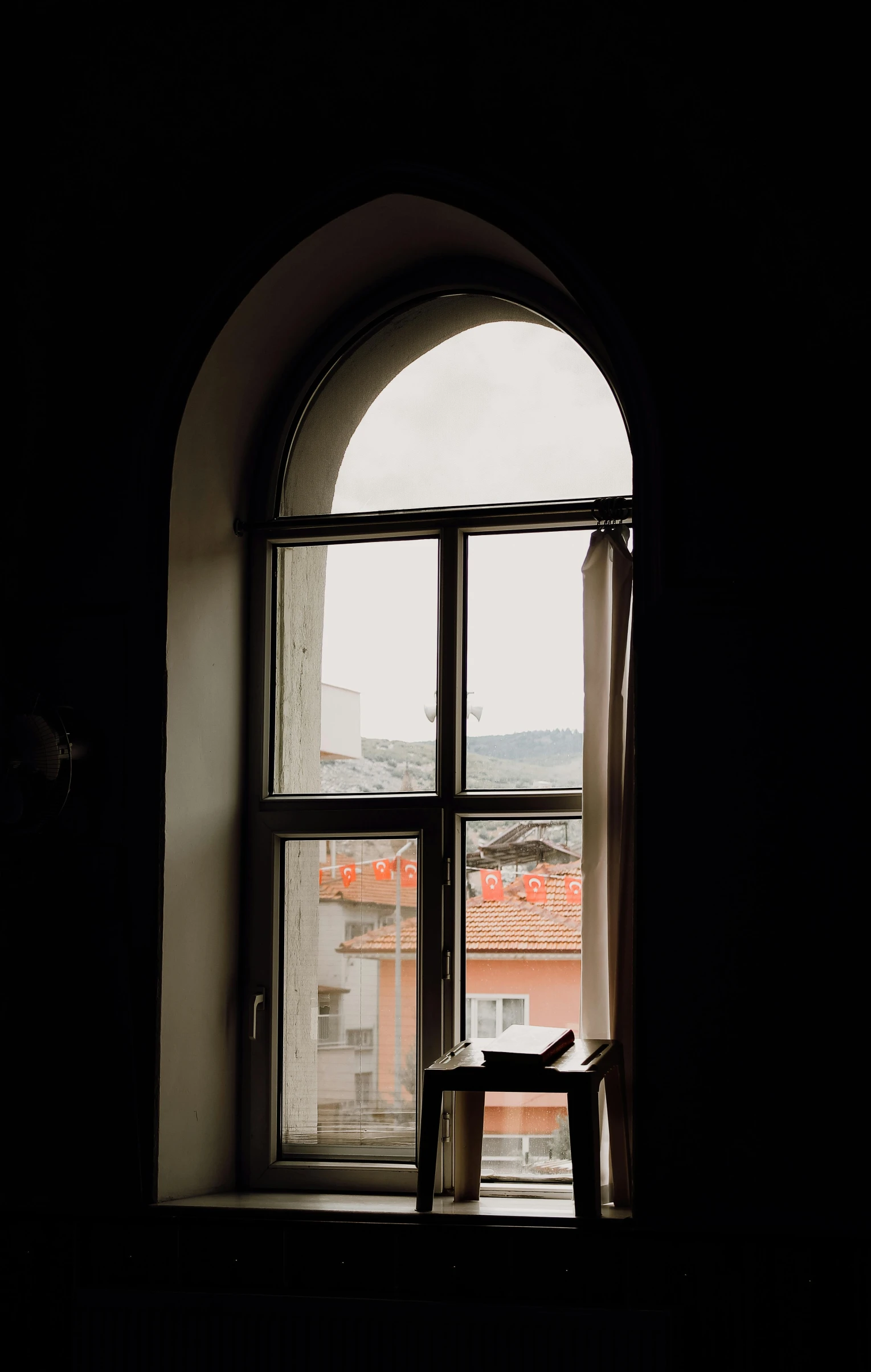 the open window is reflecting the view of the city