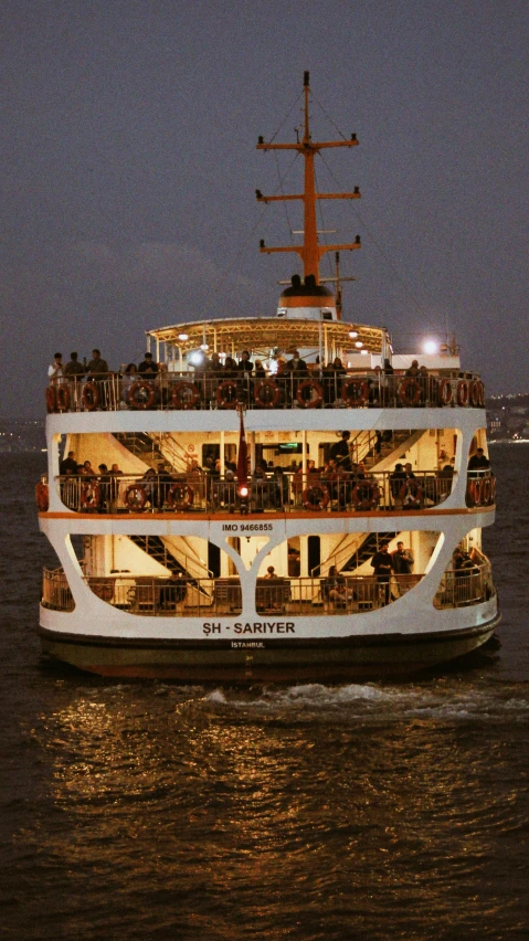 a large cruise ship sailing across the water at night