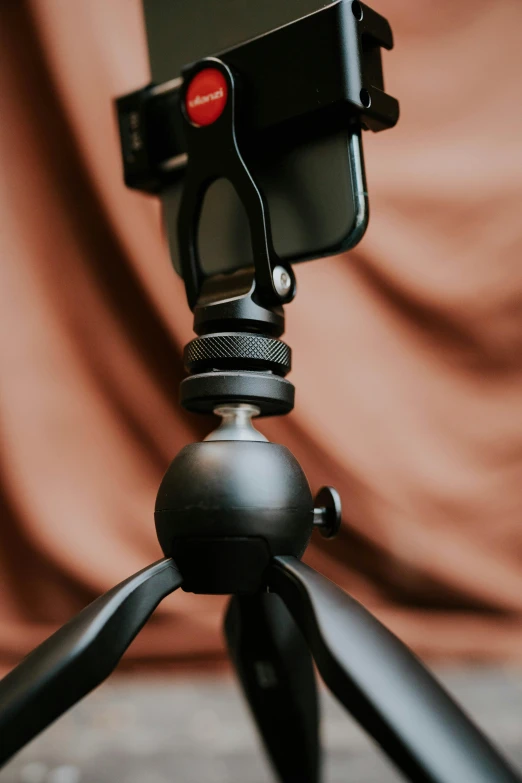 a camera tripod is open and closed to show the lens