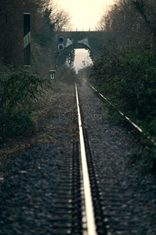 the train tracks cross under an overpass in this image