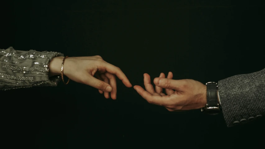 two people touching hands, each touching one another