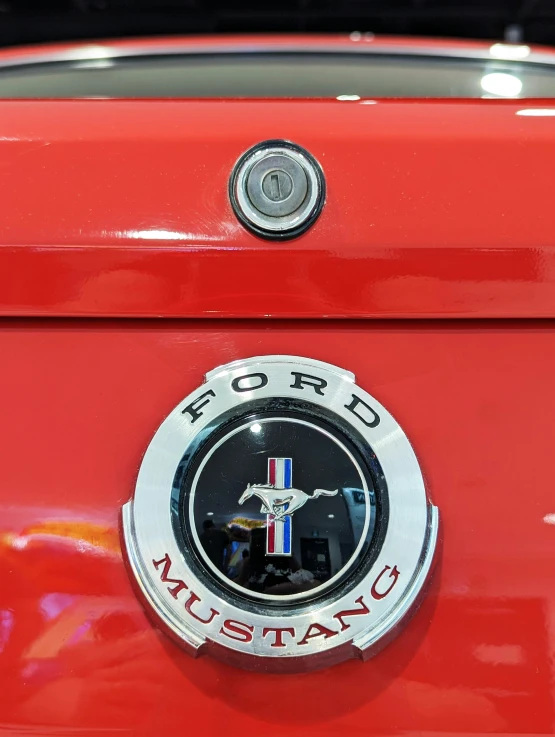 the front of a red mustang with a horse on it