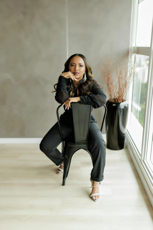 a woman sits in an office chair in a room