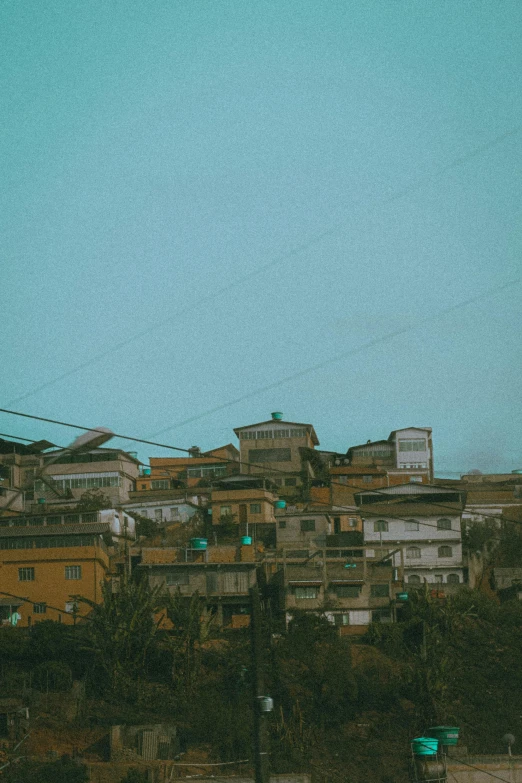 a bird flying in front of buildings and wires