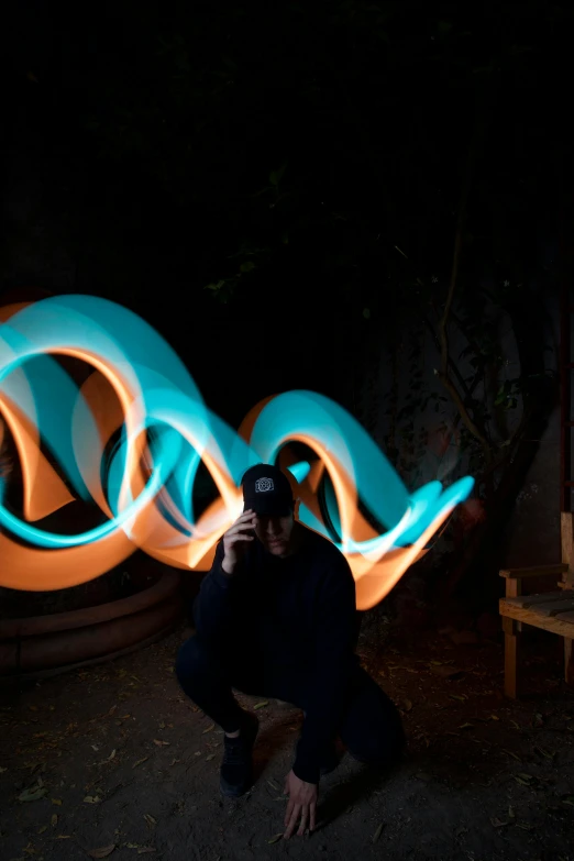 a man standing in front of a blue and orange light