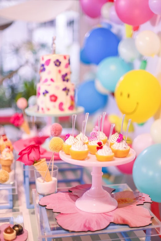 a table topped with small cakes and desserts