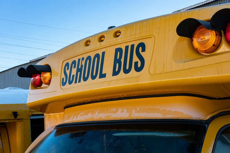 an rear view of a school bus with its lights on