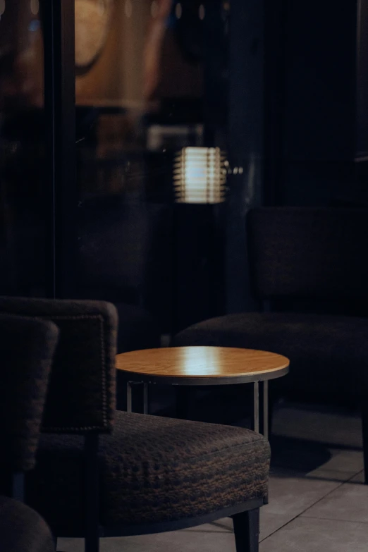 three chairs sitting in front of a round table