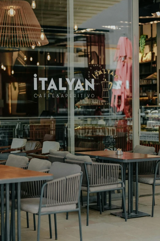 a restaurant with tables, chairs and a sign that reads i italian