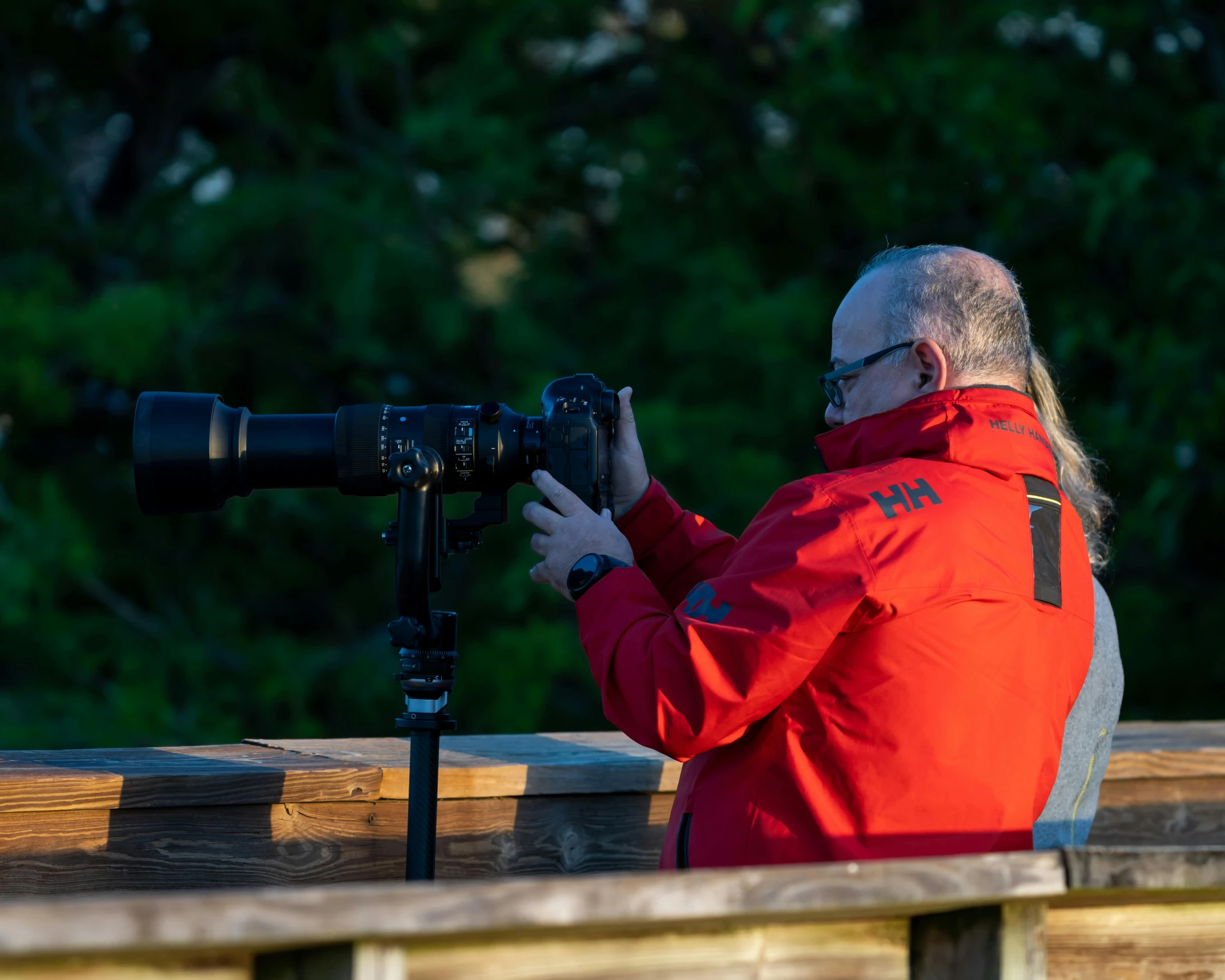 a person with a camera by the fence