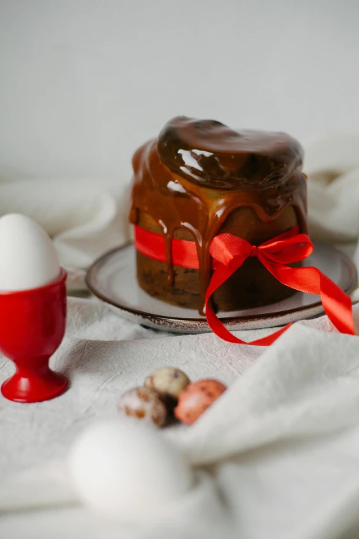 chocolate cake, an egg and other treats are on the cloth