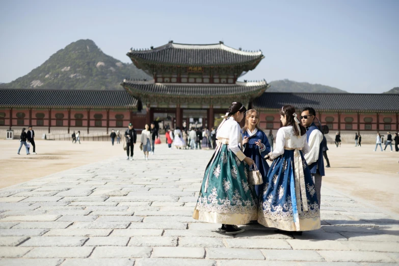 three people dressed in asian clothing posing for a po