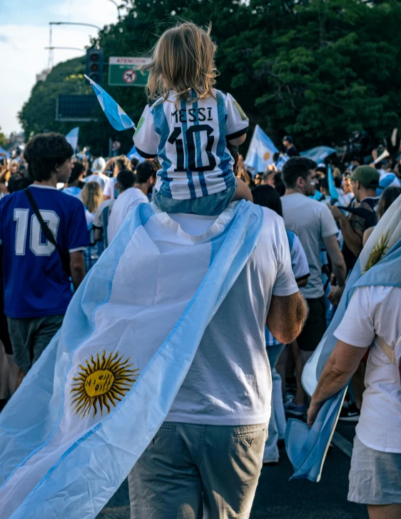 people walking in the street, holding flags, and scarves