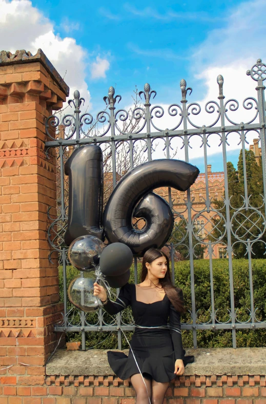 a woman is holding giant balloons in the shape of a number