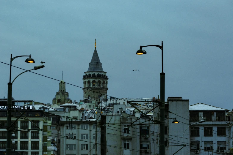 an image of an old building with lights and a tall tower