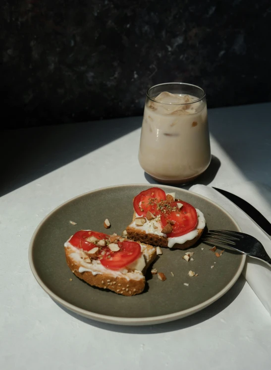 a plate with two pieces of toast covered in tomatoes