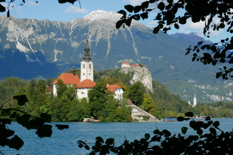 an old church and bell tower is near the water