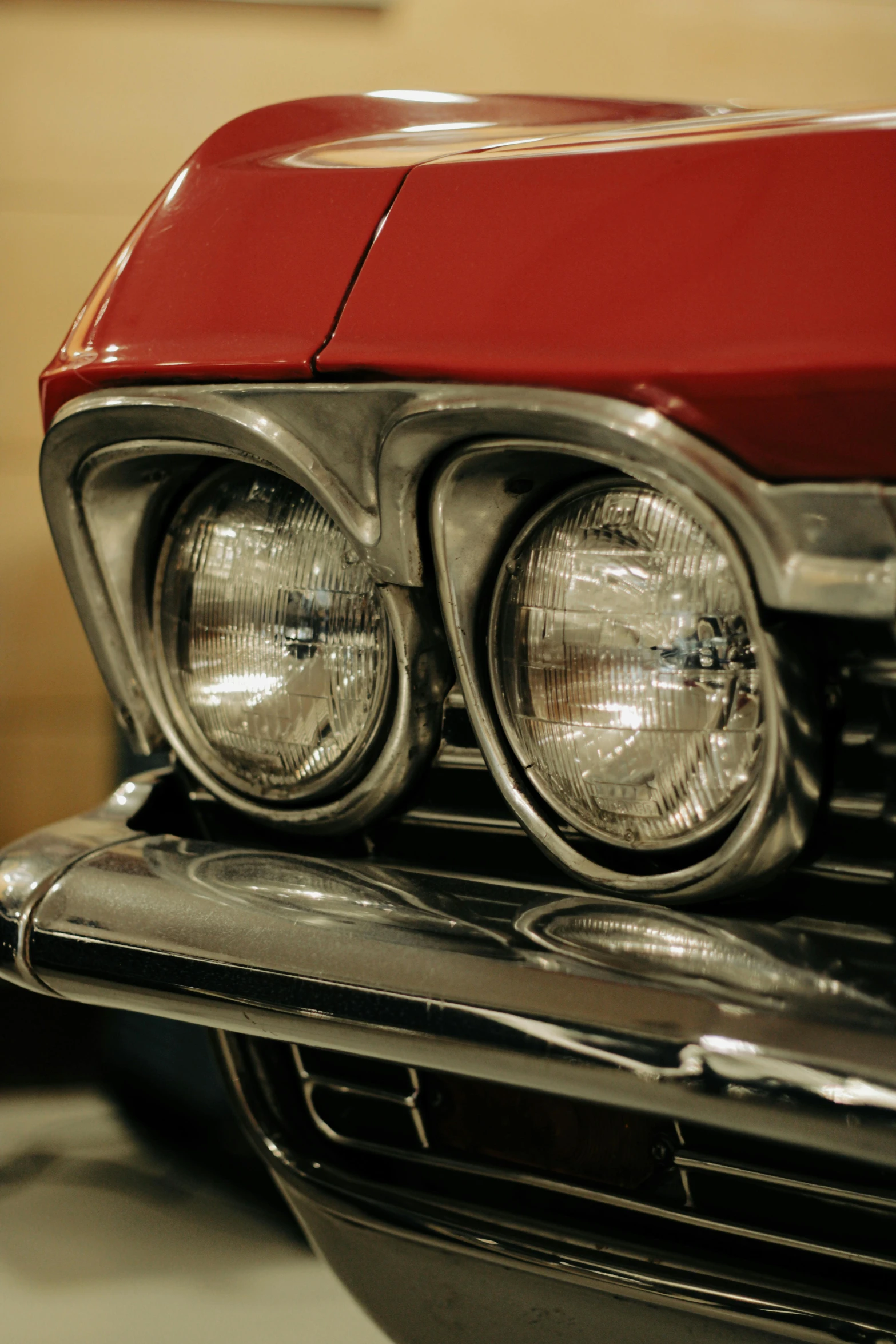 a red and black car with its lights on