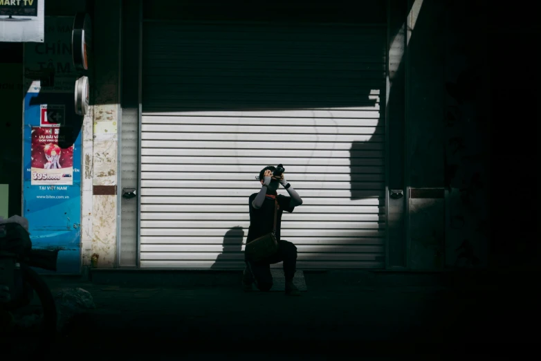 person taking po while smoking on cell phone in street