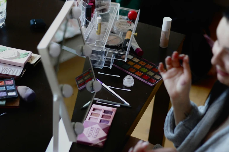 makeup sits on a black table with a clear plastic box